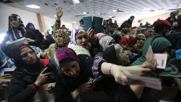 Women present their passports as they ask for permits to cross into Egypt at the Rafah border  Egypt  Gaza REUTERS