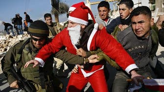 Palestinians dressed as Santa Claus protest in Bethlehem 