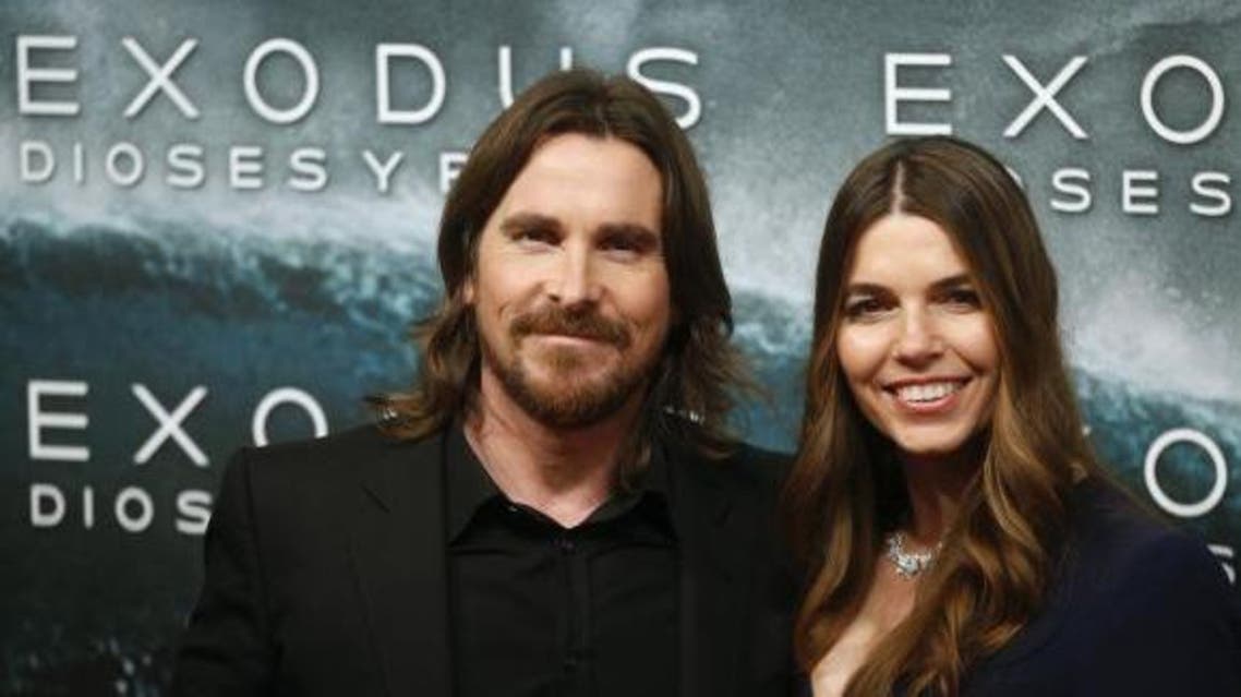 Cast member Christian Bale (L) and his wife Sibi Blazic pose for photographs as they arrive for the film world premiere of ''Exodus: Gods and Kings'' in Madrid , December 4, 2014.