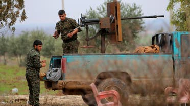 Fighters of the Kurdish People's Protection Units (YPG) manage weapons at the back of a pick-up truck in the southern countryside of Ras al-Ain December 20, 2014. Reuters
