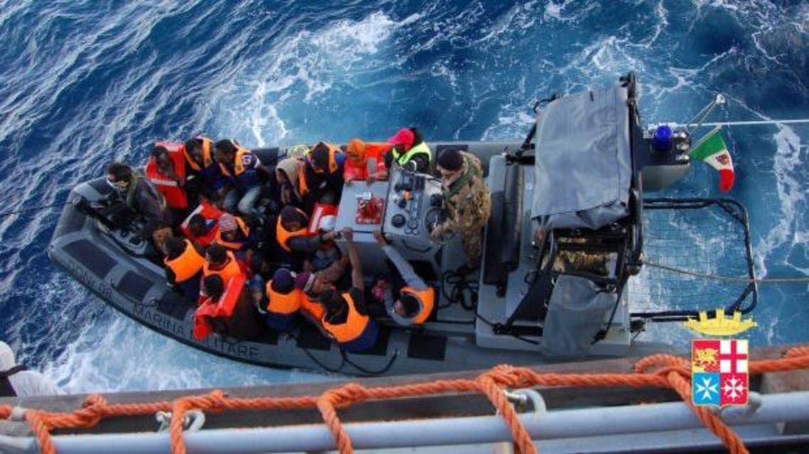 A handout picture provided by the Italian Navy Press Office shows members of the Italian Navy rescuing migrants from small boat carrying 233 people off the coast of a Sicilian island. (EPA/ITALIAN NAVY PRESS OFFICE/HANDOUT)