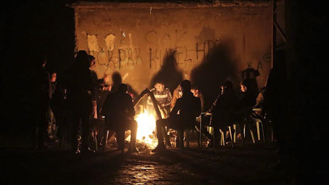 Kurdish people gather around bonfire on December 27, 2014, at Cizre in Sirnak where clashes left three killed. (AFP)
