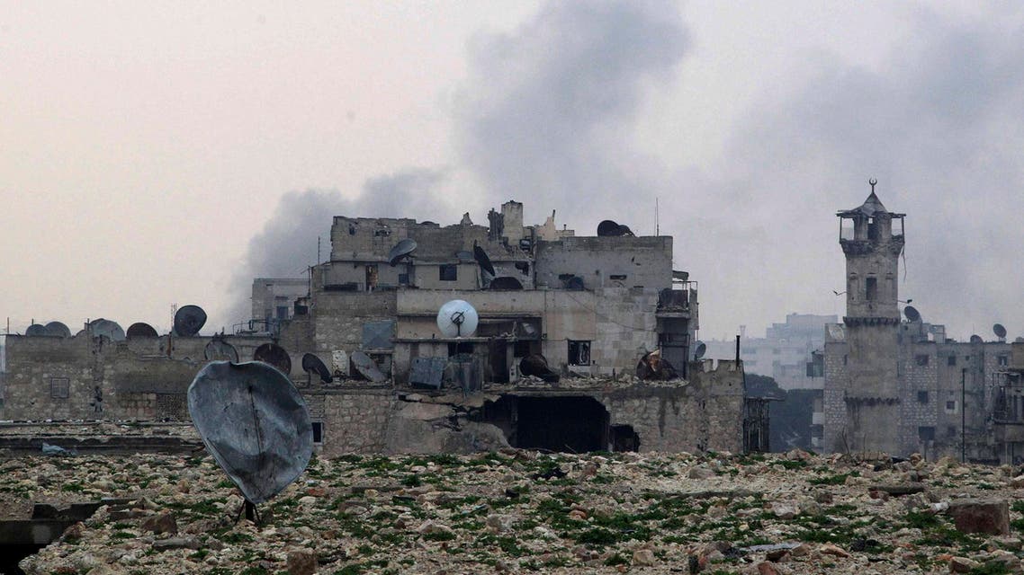 Smoke rises behind damaged buildings after what activists said was shelling by forces loyal to Syria's President Bashar al-Assad in Aleppo December 28, 2014. (Reuters)