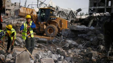Palestinian workers participate in efforts to clear the rubble of a school, that witnesses said was destroyed by Israeli shelling during the most recent conflict in Gaza. (File photo: Reuters)