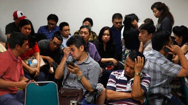 Family members of passengers onboard AirAsia flight QZ8501 react at a waiting area in Juanda International Airport, Surabaya December 28, 2014. (Reuters)