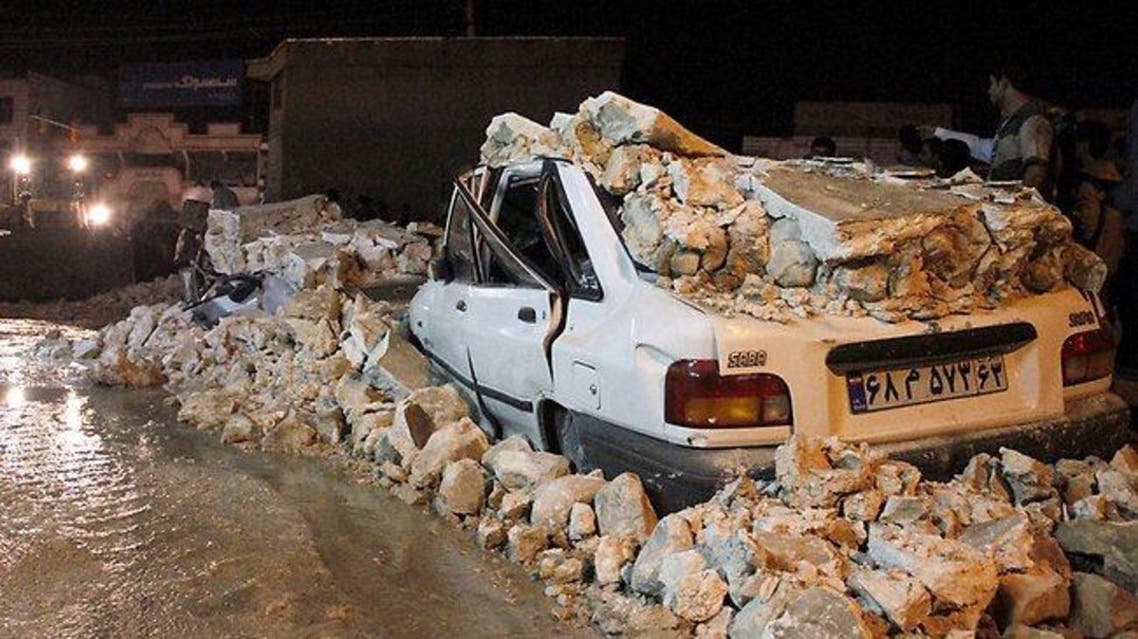 A wrecked car lies amid rubble after an earthquake struck the Iranian city of Borazjan in 2013. Picture: AFP Source: AFP