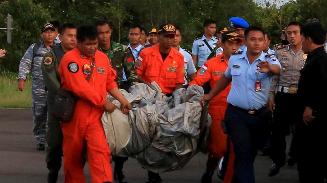 Members of the Search and Rescue Agency carry debris recovered from the sea presumed from missing Indonesia AirAsia flight QZ 8501. (Reuters)