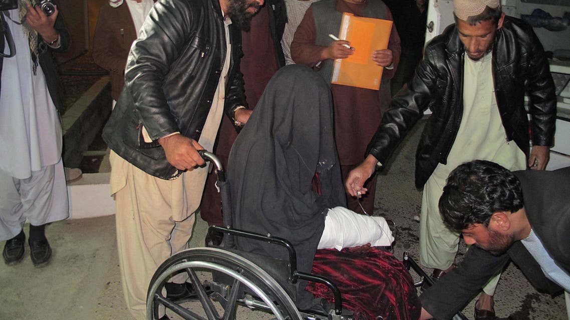 A wounded Afghan woman (C) is brought to the hospital in Helmand province early on Jan. 1, 2015 after a rocket fired during fighting between Afghan forces and insurgents killed at least 15 wedding guests late on December 31. (AFP)