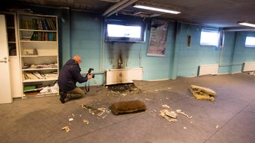 A police officer investigates a suspected arson in the basement of a mosque in the southern Swedish town of Eslov December 29, 2014. reuters