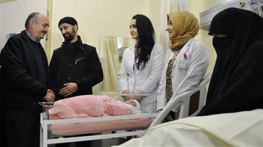 Health Minister Mehmet Müezzinoğlu (L) visits the first baby born this year in Istanbul at a hospital in Zeytinburnu district. Dogan news agency