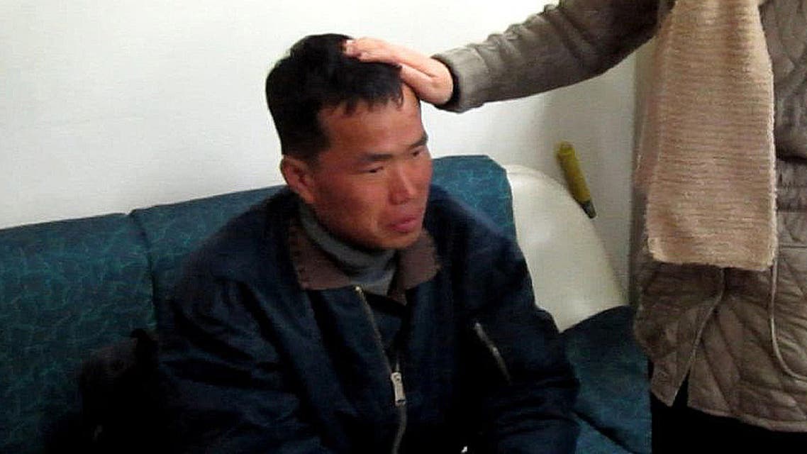 In this Jan. 24, 2014 image taken from a video footage released by Guro Police, Kim Seong-baek, left, meets with his mother, not identified her name, after he was rescued from a salt farm, at Guro Police Station in Seoul, South Korea. AP