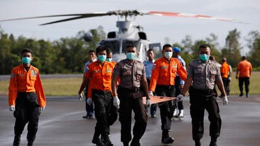 Indonesian Search and Rescue and police carry a stretcher across the tarmac after loading the recovered remains of two passengers from AirAsia flight QZ8501 into an ambulance, at the airport in Pangkalan Bun, Central Kalimantan January 2, 2015. (Reuters)