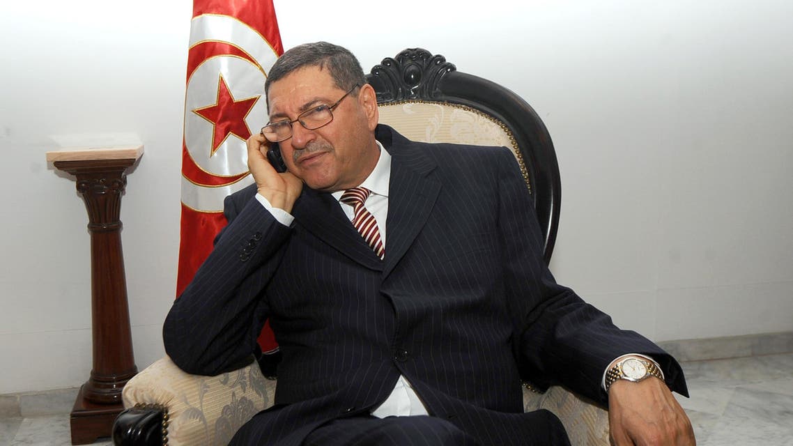 A file picture taken on April 5, 2011 shows Tunisian ex-interior minister Habib Essid making a phone call before meeting with his Italian counterpart in Tunis. (AFP)