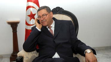  A file picture taken on April 5, 2011 shows Tunisian ex-interior minister Habib Essid making a phone call before meeting with his Italian counterpart in Tunis. (AFP)