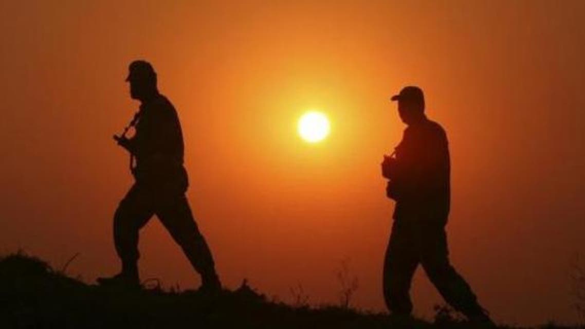 Border Security Force (BSF) soldiers patrol as they are silhouetted against the setting sun at the fenced border with Pakistan. (File photo Reuters)