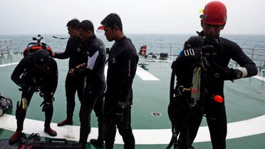 A group of divers prepares their gear on the deck of the Search and Rescue (SAR) ship KN Purworejo during a search operation for passengers onboard AirAsia Flight QZ8501 in the Java Sea January 4, 2015. (Reuters)
