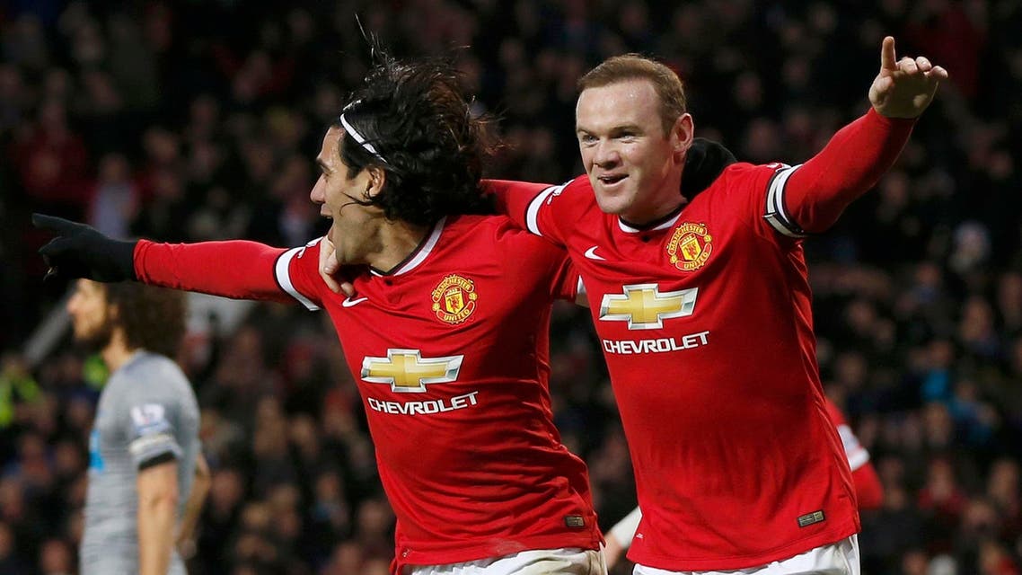 Manchester United's Wayne Rooney (R) celebrates after scoring a goal against Newcastle with team-mate Radamel Falcao during their English Premier League soccer match at Old Trafford in Manchester, northern England Dec. 26, 2014. (Reuters)