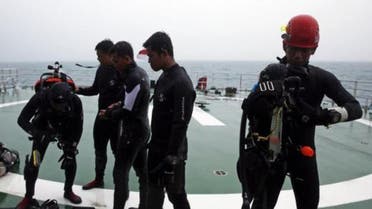 A group of divers prepares their gear on the deck of the Search and Rescue (SAR) ship. (Reuters)