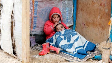 A Syrian refugee girl sits with her brother at a makeshift settlement in Bar Elias in the Bekaa valley. Reuters