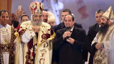 Egyptian President Abdel Fattah al-Sisi (2nd R) talks next to Coptic Pope Tawadros II as he attends Christmas Eve Mass at St. Mark's Cathedral. (Reuters)