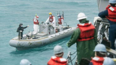 This handout released by the US Navy on January 4, 2015 shows the recovery team from the Arleigh Burke-class destroyer USS Sampson (DDG 102) signaling the boat deck crew while conducting search and recovery operations in support of the Indonesian-led AirAsia flight QZ8501 search efforts in the Java Sea. Reuters
