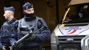 French police officers stand guard in front of the headquarters of French newspaper Liberation. (AFP)
