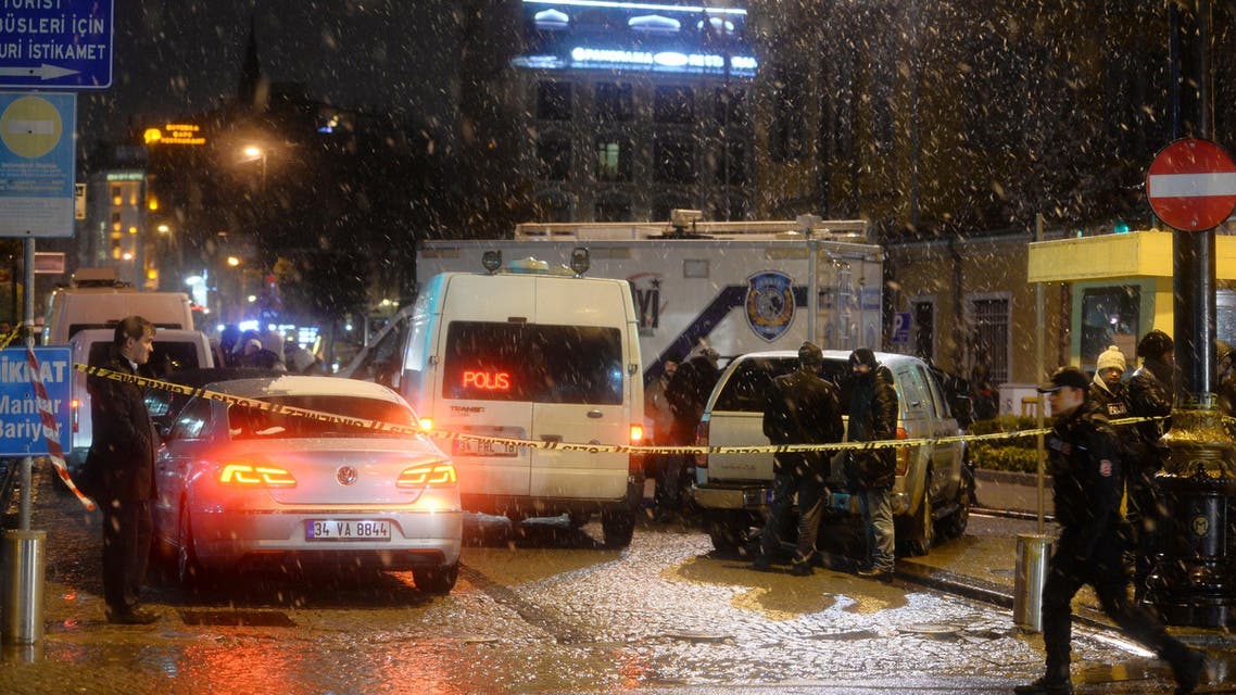 Turkish security gather outside a police station where one police officer was killed and another injured after a suicide bomber blew herself up in Istanbul, Turkey, Tuesday, Jan. 6, 2015. AP