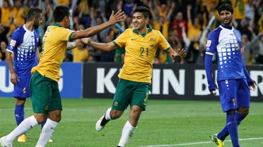 Australia's Massimo Luongo (C) celebrates his goal with teammate Tim Cahill next to Kuwait's Mesaed Alenzi (R) during their Asian Cup Group A soccer match against Kuwait at the Rectangular stadium in Melbourne January 9, 2015. Reuters