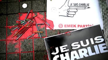 Broken pens and placards that read: "I am Charlie" lay on the ground as people gather outside the French consulate to pay tribute to the victims of the French satirical newspaper Charlie Hebdo, in Istanbul, Turkey, Friday, Jan. 9, 2015. (AP)