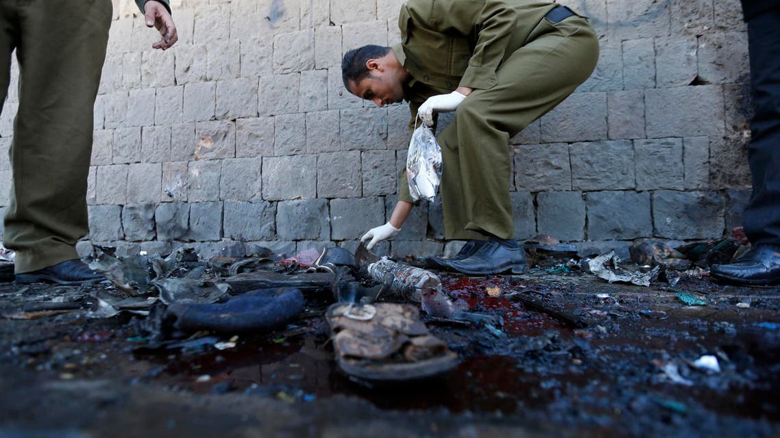 Policemen collect evidence at the scene of a car bomb attack outside a police college in Sanaa January 7, 2015. (Reuters)