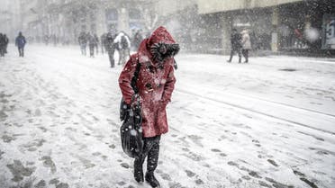  A woman walks under the snow in Istanbul on January 7, 2015. AFP