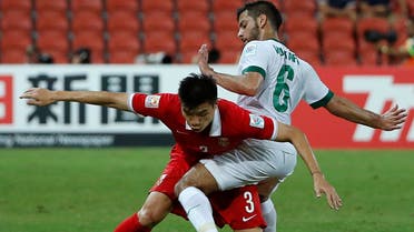 China's Mei Fang (L) and Saudi Arabia's Mustafa Al-Bassas fight for the ball during their Asian Cup Group B soccer match at the Brisbane Stadium in Brisbane January 10, 2015. (Reuters)