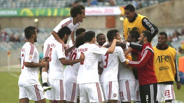 UAE players celebrate goal by UAE's Ahmed Khalil (obscured) during their Asian Cup Group C soccer match against Qatar at the Canberra stadium in Canberra January 11, 2015. (Reuters)