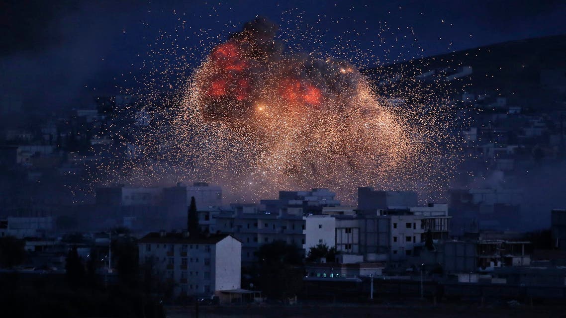 In this Oct. 20, 2014, file photo, thick smoke and flames from an airstrike by the U.S.-led coalition rise in Kobani, Syria, as seen from a hilltop on the outskirts of Suruc, at the Turkey-Syria border. AP