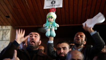 Palestinian Hamas-hired employees shout slogans after breaking past the gate of the Palestinian cabinet headquarters to demand their pay, in Gaza City January 13, 2015. Reuters 
