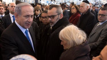 Israeli Prime Minister Benjamin Netanyahu, left, speaks briefly with relatives of Yoav Hattab, one of four French Jews killed in an attack on a kosher grocery store in Paris last week, during their funeral service, in Jerusalem, Tuesday, Jan. 13, 2015. AP