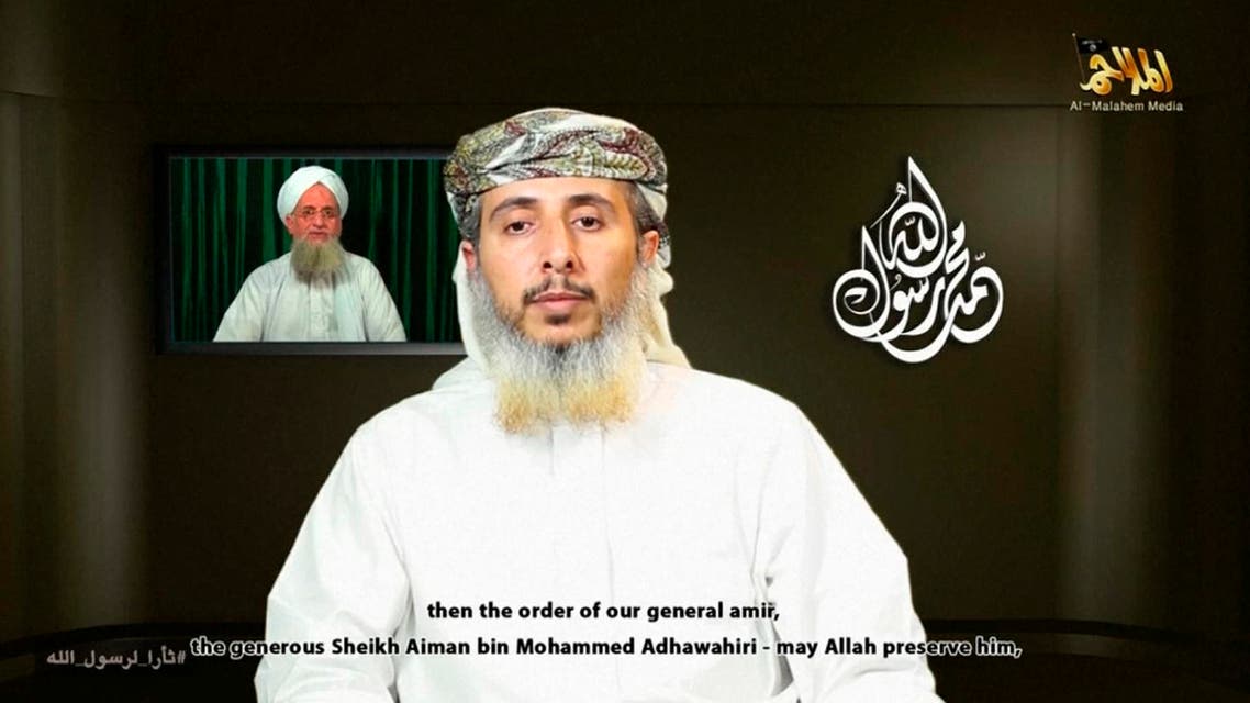 Nasser bin Ali al-Ansi, a leader of the Yemeni branch of al Qaeda (AQAP), speaks as an image of Al Qaeda chief Ayman al-Zawahiri (rear L) is seen in this still image taken from a social media website on Jan. 14, 2015. (Reuters)
