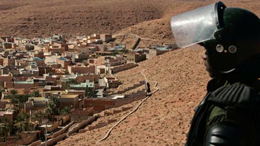 An Algerian police officer stands guard outside the desert city of Ghardaia (AP)