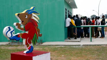 Chuku Chuku, the official mascot of the tournament is seen as fans wait in line to buy tickets for the upcoming African Nations Cup outside the Estadio de Bata "Bata Stadium" which will host the opening ceremony on Saturday, in Bata Jan. 15, 2015.  (Reuters)