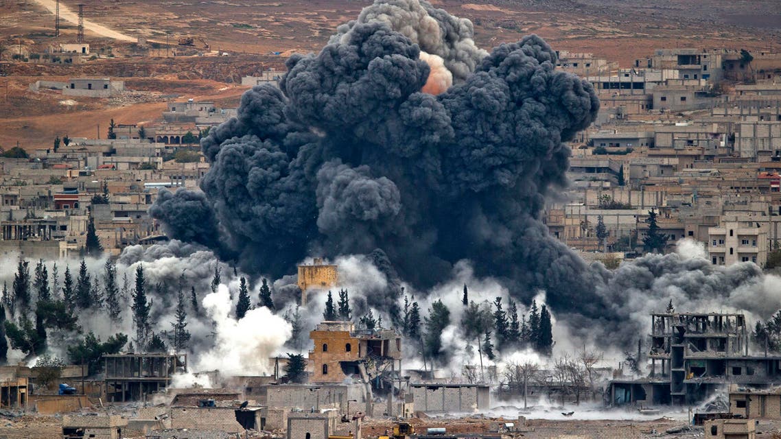 In this Monday, Nov. 17, 2014 file photo, smoke rises from the Syrian city of Kobani, following an airstrike by the U.S.-led coalition, seen from a hilltop outside Suruc, on the Turkey-Syria border. (AP)