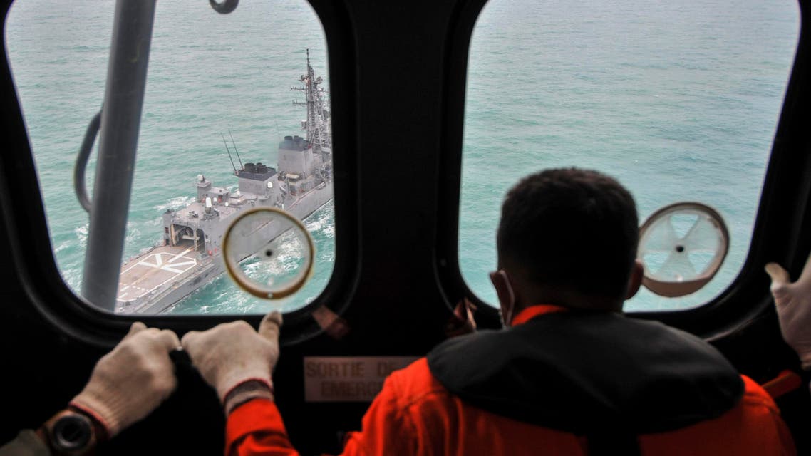 A Malaysian Navy ship is seen from an Indonesian Air Force Super Puma helicopter during a search mission for for AirAsia flight QZ8501 off the coast of Central Kalimantan January 6, 2015. REUTERS
