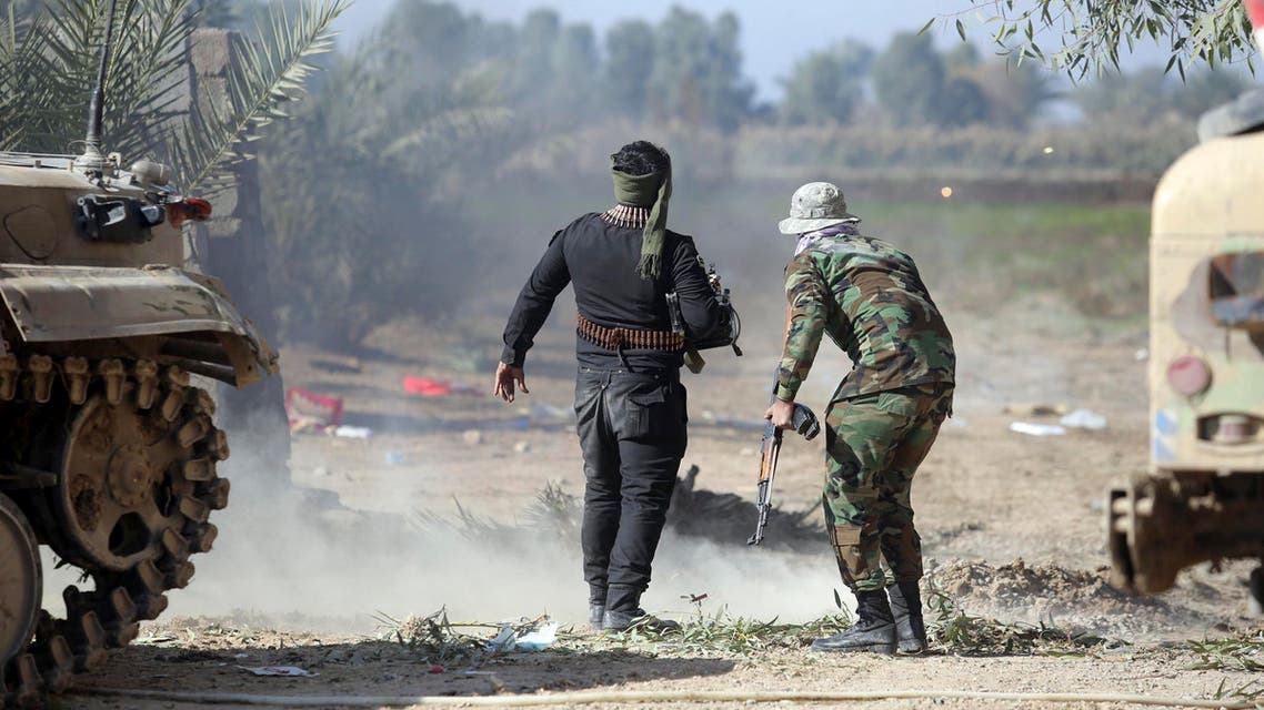 Iraqi Shi'ite fighters keep watch during fighting with Islamic State militants at Al-Nibai, north of Baghdad,January 14, 2015. (Reuters)