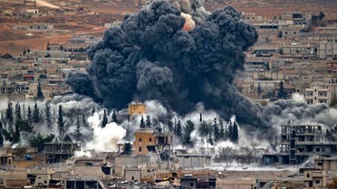 In this Monday, Nov. 17, 2014 file photo, smoke rises from the Syrian city of Kobani, following an airstrike by the U.S.-led coalition, seen from a hilltop outside Suruc, on the Turkey-Syria border. AP