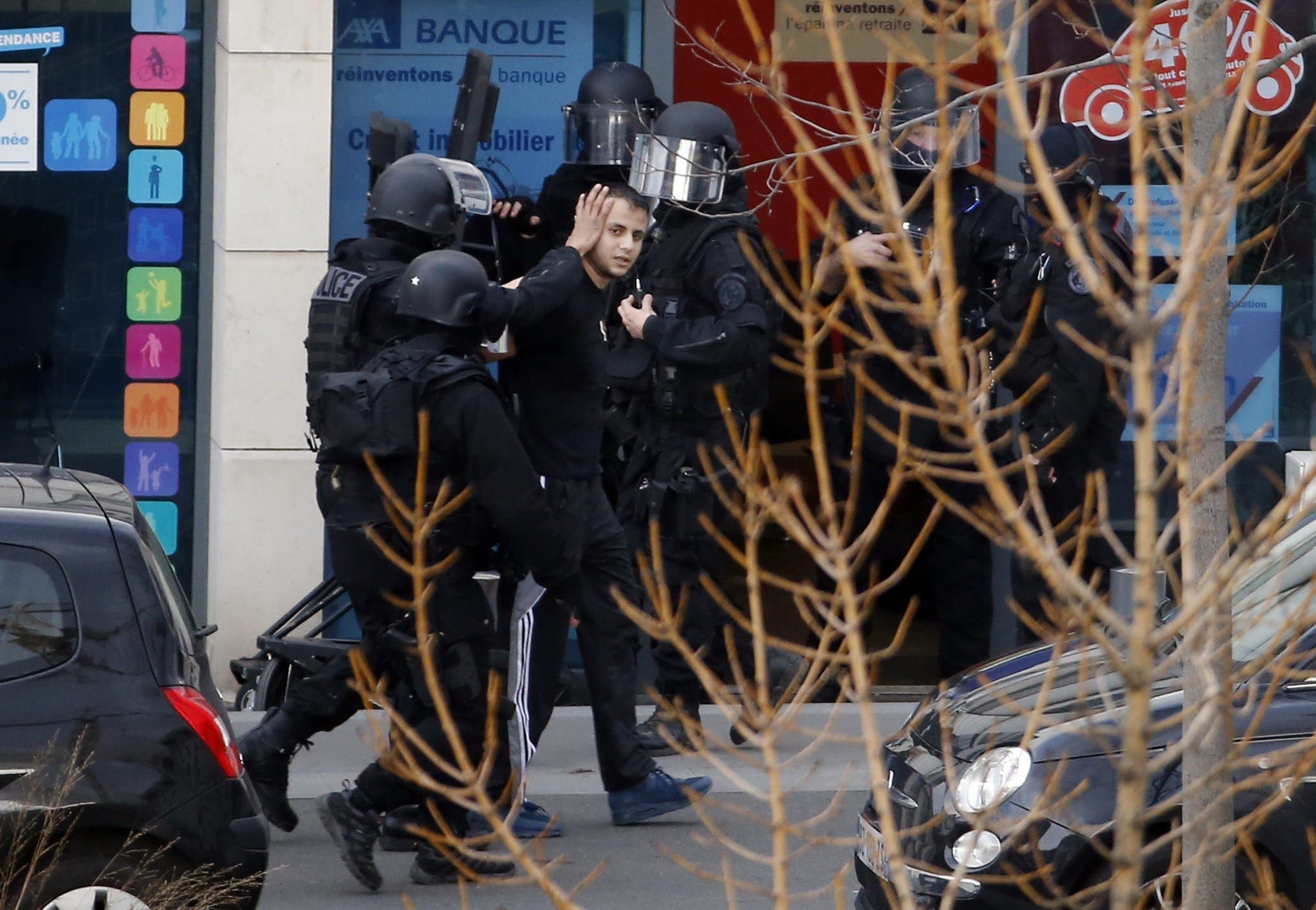 A man (C), who had holed up two hostages in a post office, is arrested by French policemen on January 16, 2015 in Colombes. (AFP)