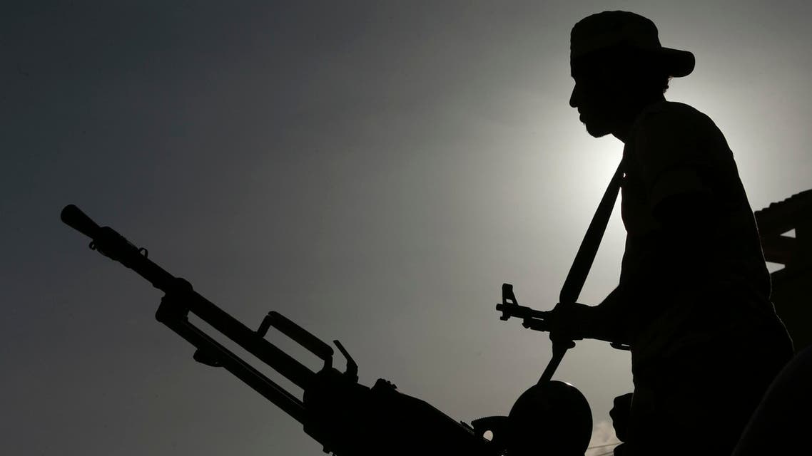 Pro-government Libyan forces, who are backed by locals, are seen silhouetted during clashes in the streets with the Shura Council of Libyan Revolutionaries reuters