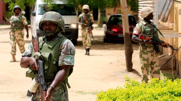 Nigerian soldiers stand guard at the offices of the state-run Nigerian Television Authority in Maiduguri, Nigeria. (AP)