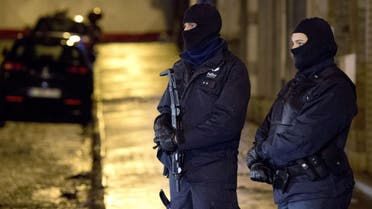Armed police officers wearing balaclavas stand near a cordoned off section of Colline street in Verviers, eastern Belgium, on January 15, 2015, after two suspects were killed during an anti-terrorist operation. AFP