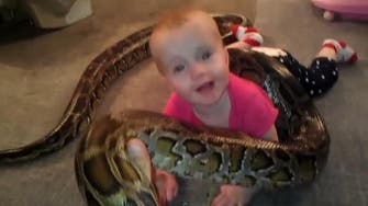 Video of snake coiled around baby goes viral
