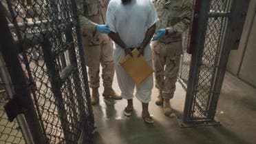 This March 30, 2010 file photo shows US military guards as they move a detainee inside Camp VI at Guantanamo Bay, Cuba. (File photo AFP) 