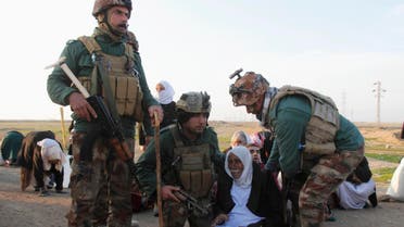 Kurdish security forces help people from the minority Yazidi sect, on the outskirts of Kirkuk January 17, 2015. (Reuters)